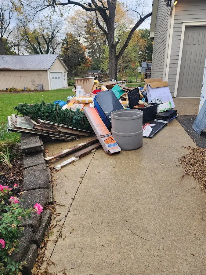 Dumpster being loaded with debris for 30 Yard Dumpster Rental in Indian River Shores